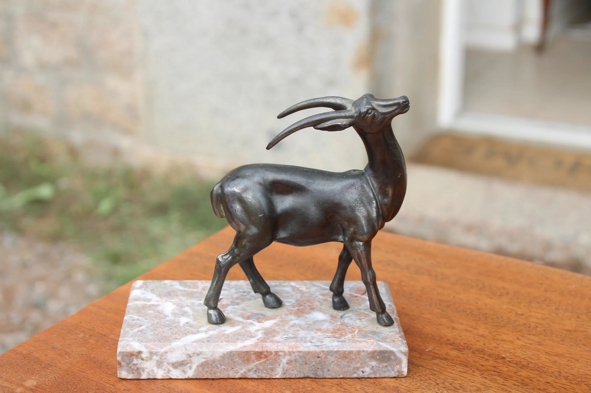 Vintage antelope gazelle bookend in patinated metal on a marble base.