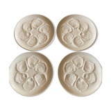 Set of four earthenware oyster plates