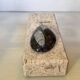 An asymmetrical travertine and fossil bookend.
