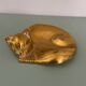Cat-shaped catchall that looks like it's sleeping.
