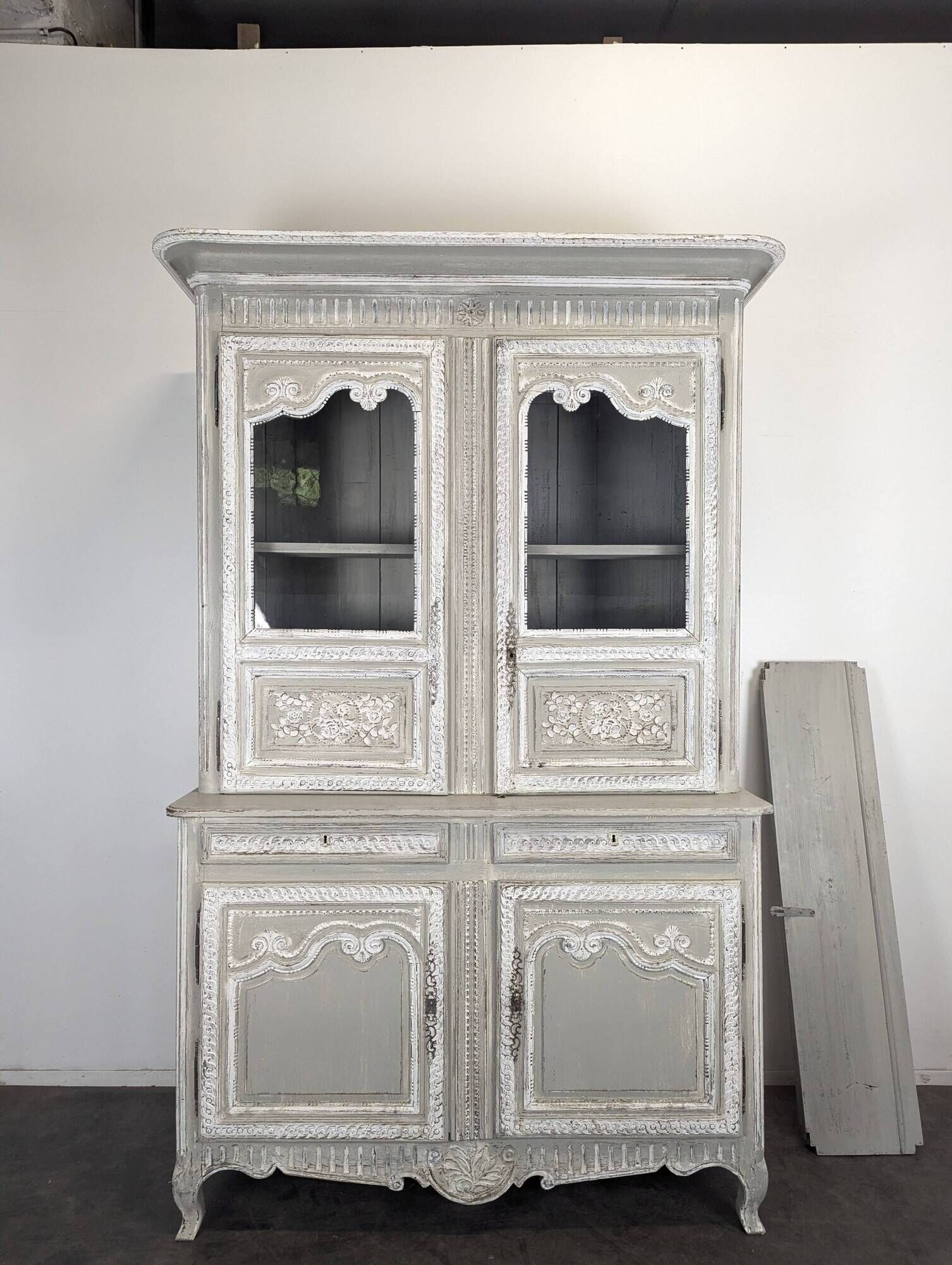 Two-body glass buffet in patinated grey and white oak.