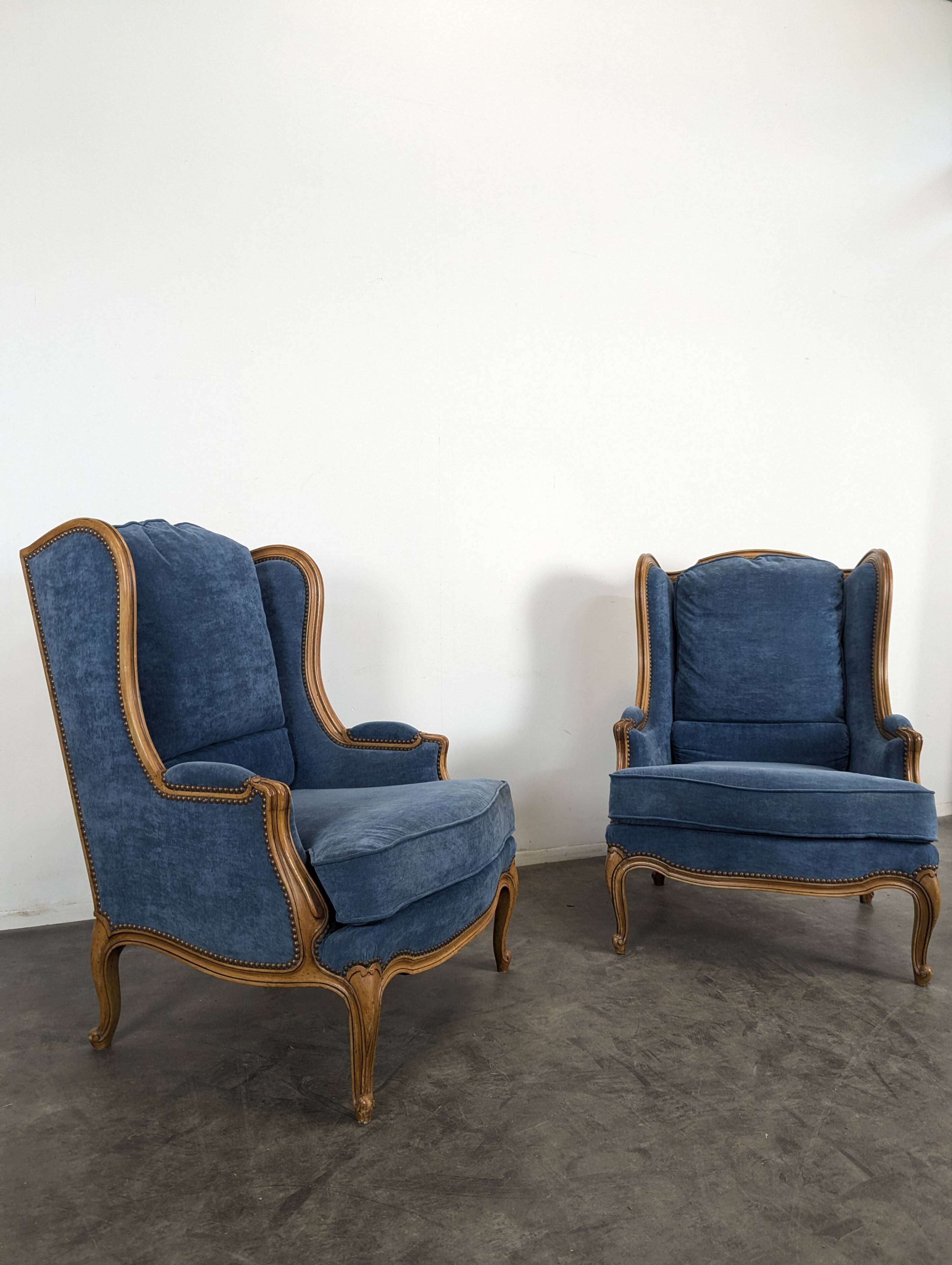Pair of Louis XV style wingback armchairs in blue velvet.