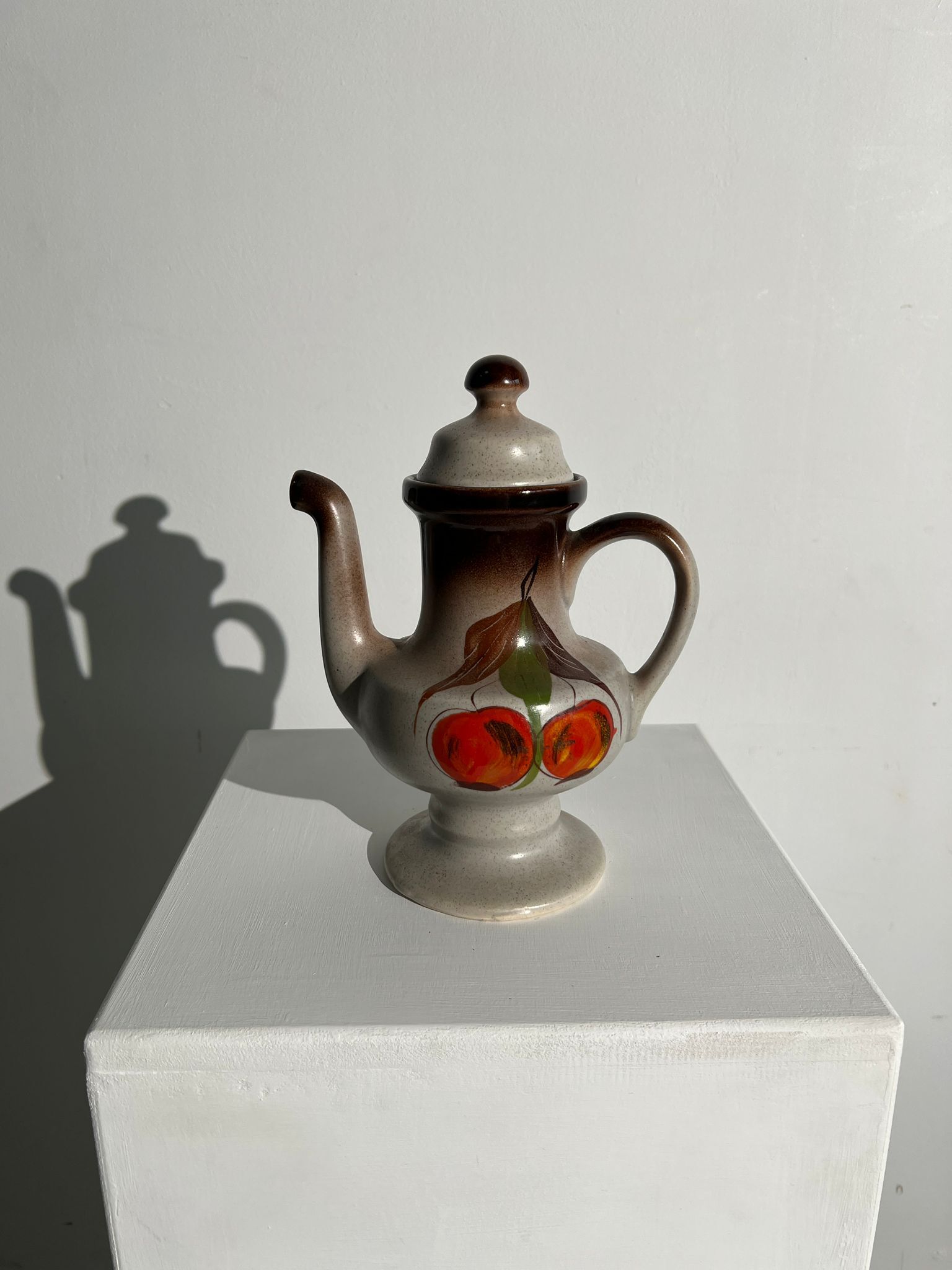 Vintage stoneware teapot with flower and fruit patterns