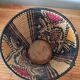 Ethnic basket in multicolored braided straw