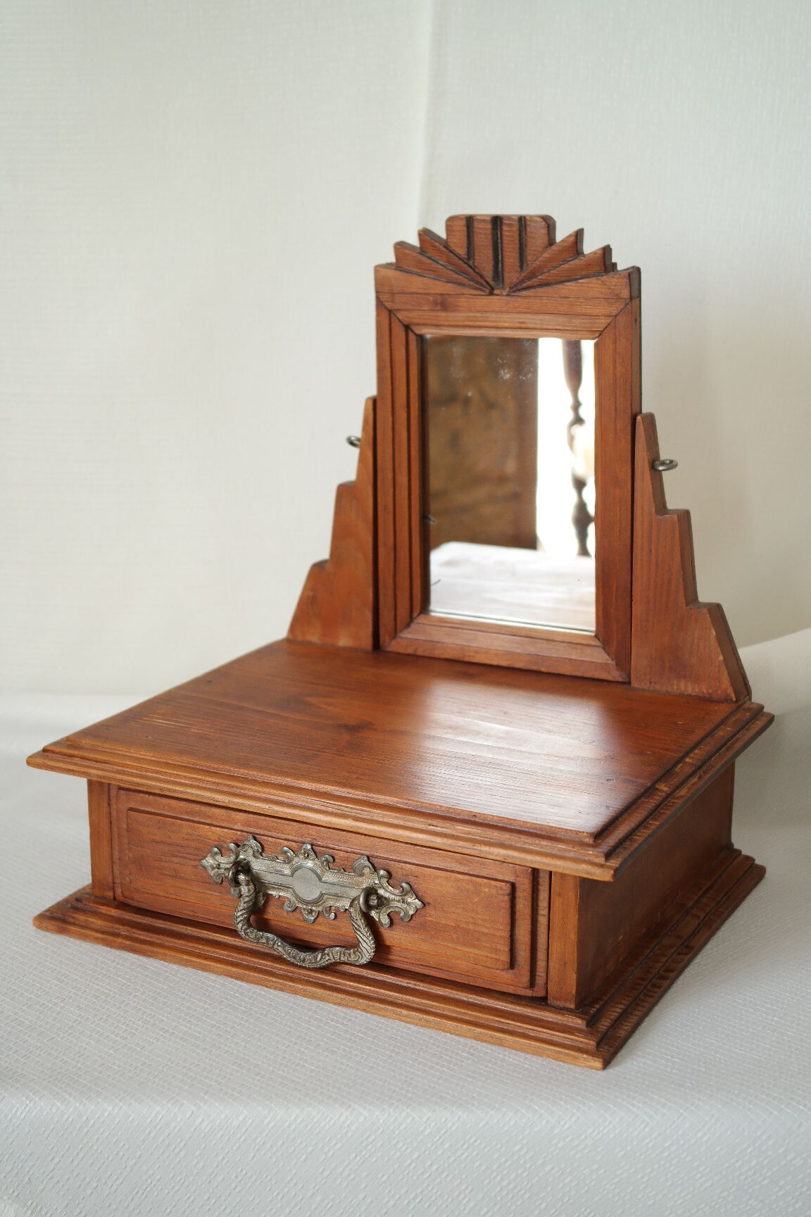 Antique wooden table mirror in Art Deco style.