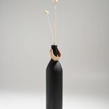 Burnt wood vase for dried flowers, leather and brass handle.