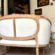 Two-seater basket bench in carved wood and beige mixed fabric, 18th century.
