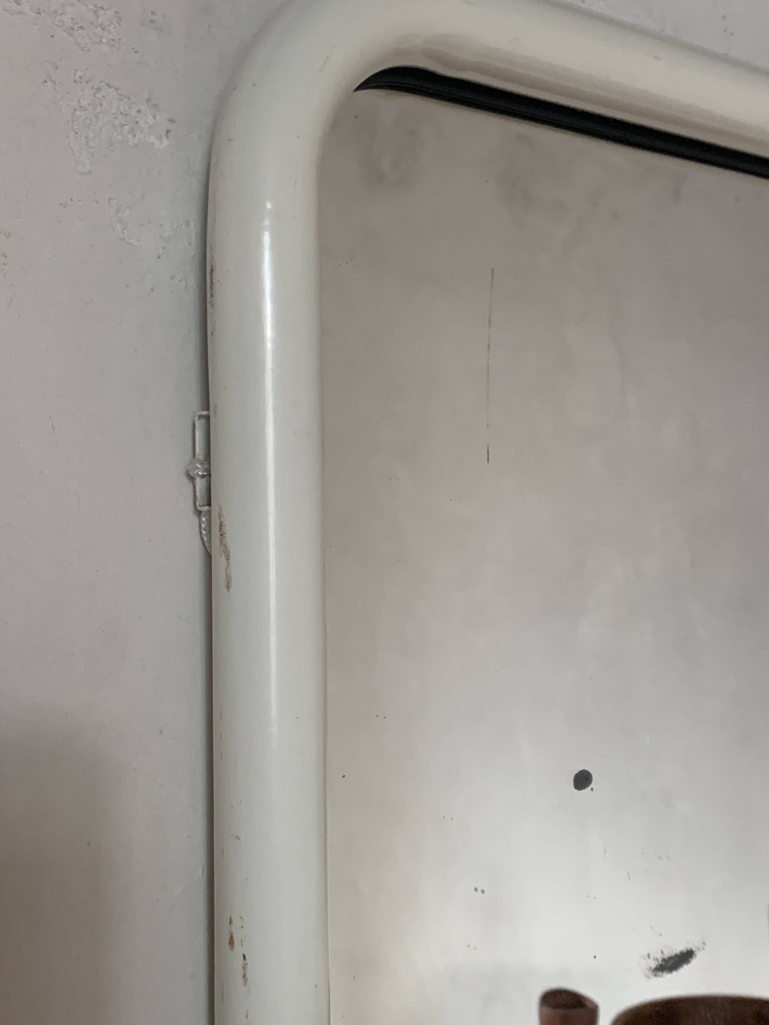 White tubular metal wall mirror