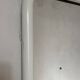 White tubular metal wall mirror