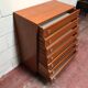 Brown teak Mid-Century chest of drawers with 7 drawers from the 1960s, sleek lines, discreet base.