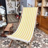 Vintage folding deckchair with yellow striped canvas