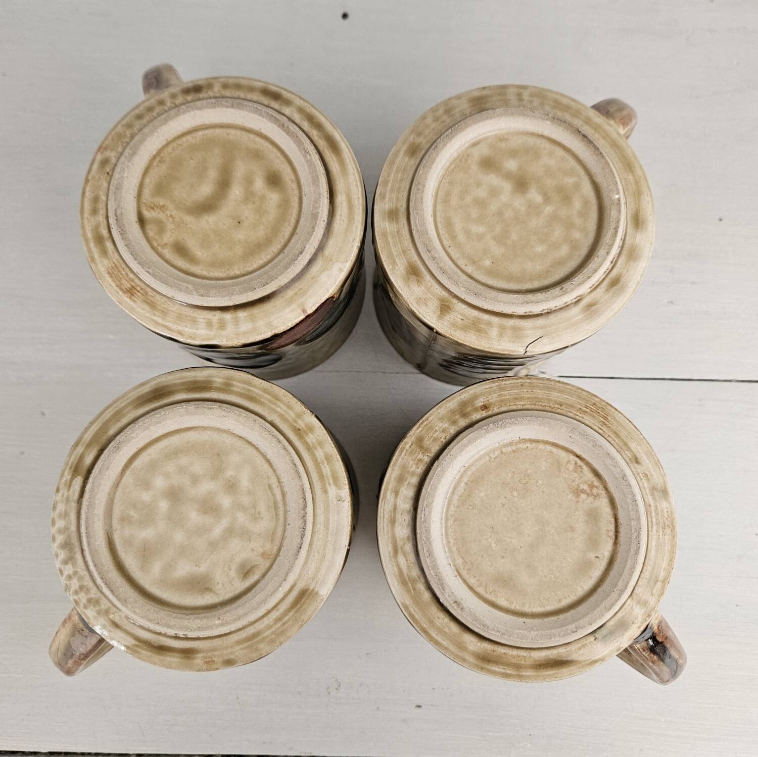 Set of 4 ceramic mugs, glazed stoneware, assorted vintage designs.