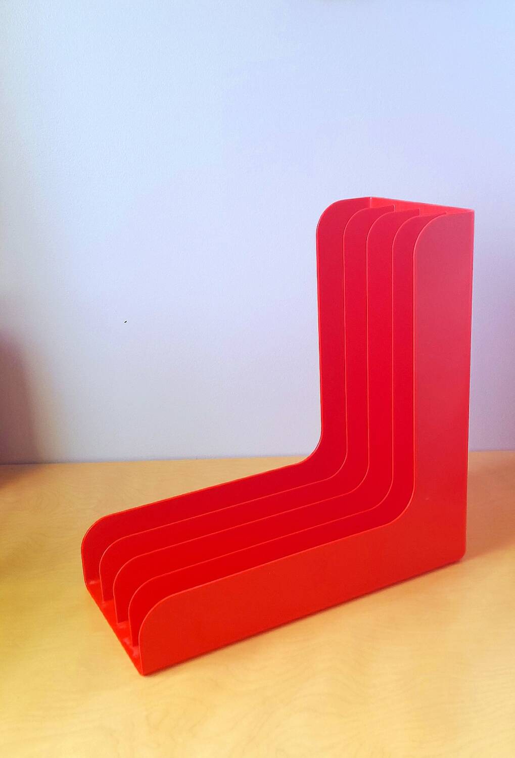 33 rpm vinyl record rack, in orange 70s plastic.