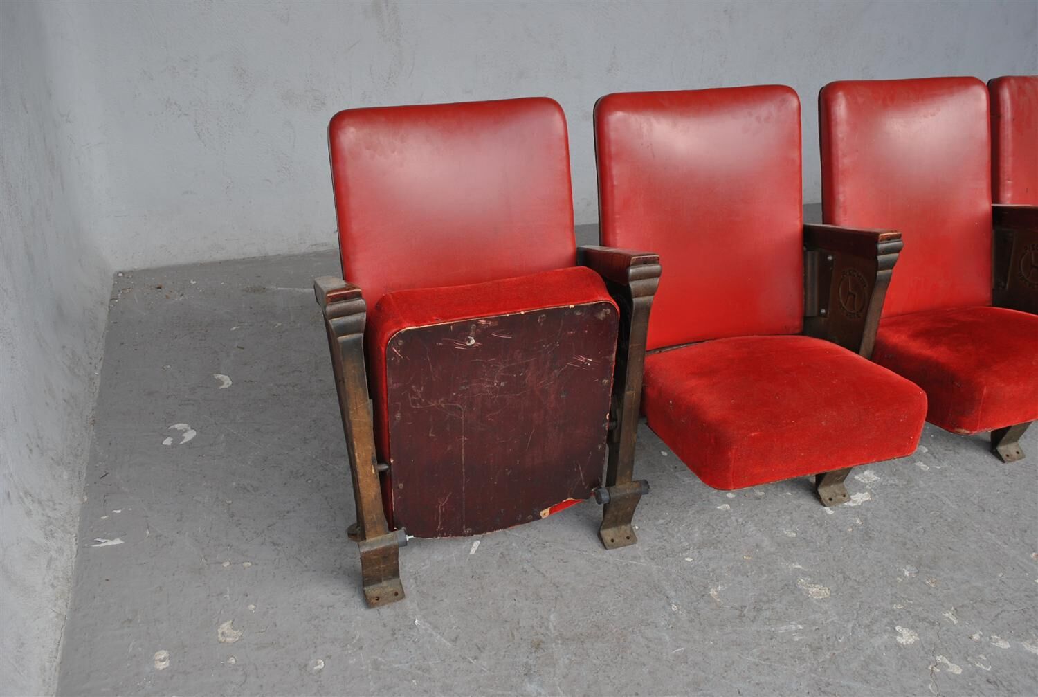 Series of 5 red skai and patinated cast Theater chairs