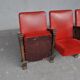 Series of 5 red skai and patinated cast Theater chairs