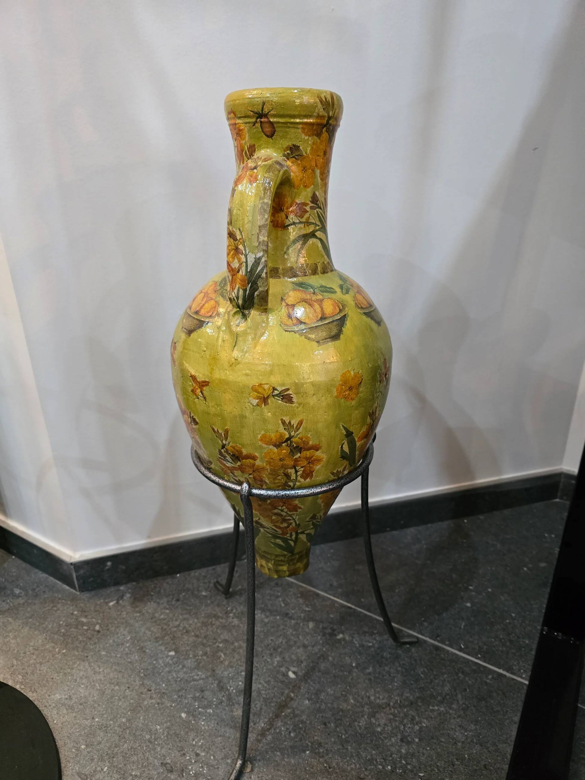 Large decorative vase with handles – painted floral design – on a metal stand