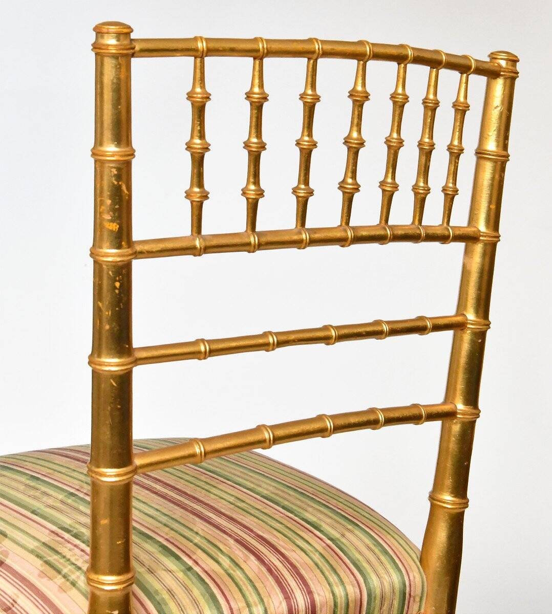 Pair of golden wood chairs in a bamboo style.