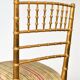 Pair of golden wood chairs in a bamboo style.