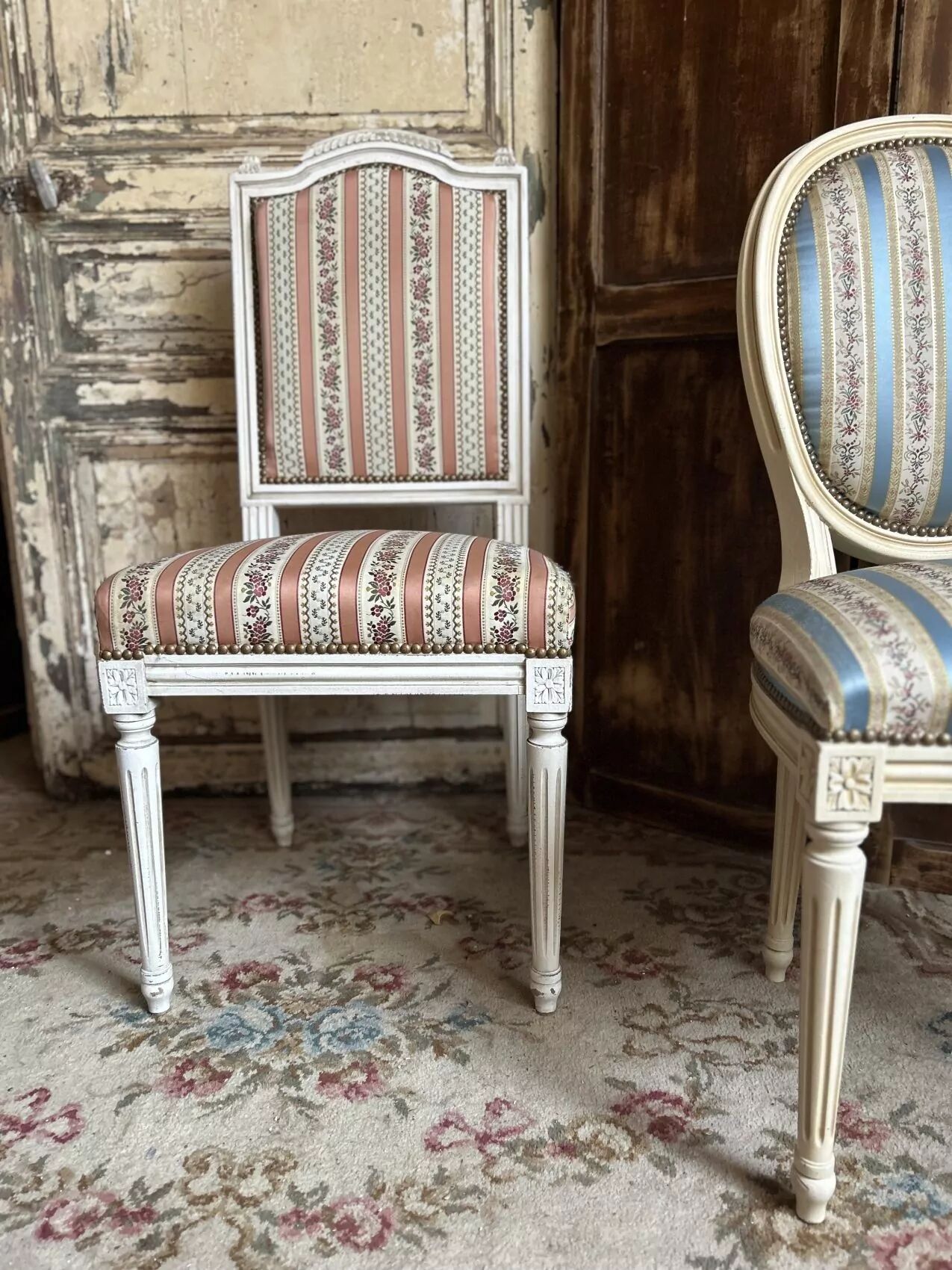 Pair of Louis XVI style chairs in painted wood and satin, classic elegance.
