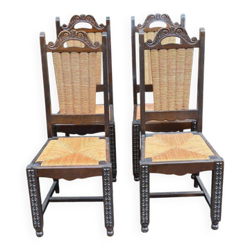 4 Basque solid wood dining chairs with carved straw seats.