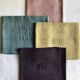 Suite of four tinted antique napkins
