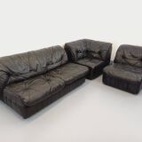 Vintage corner sofa composed of 3 modules in black leather with integrated bed.