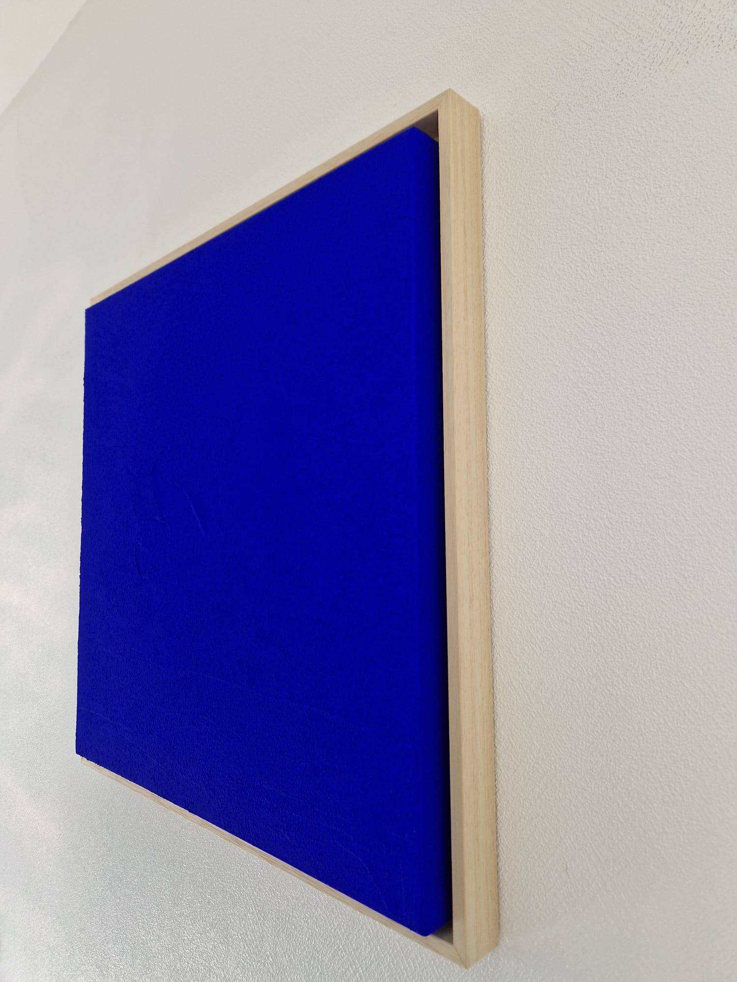 Framed monochrome blue abstract painting.