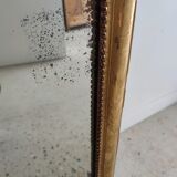 Long wooden mirror and gilded stucco with pearl rays H: 2m45 L: 40cm