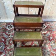 19th-century English library staircase, green leather with gold detailing.