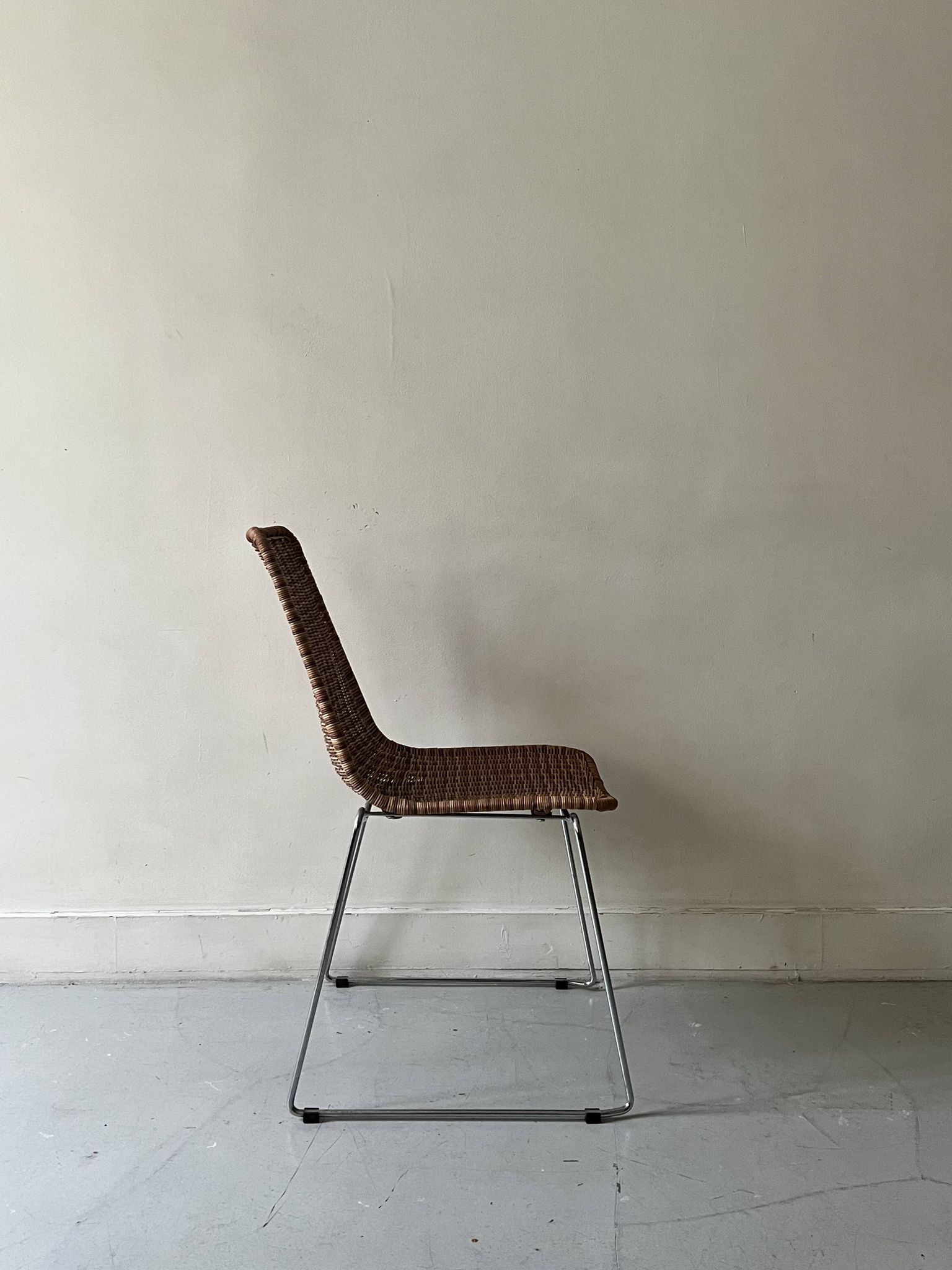 Chair design in rattan, woven wicker and chrome wire metal.