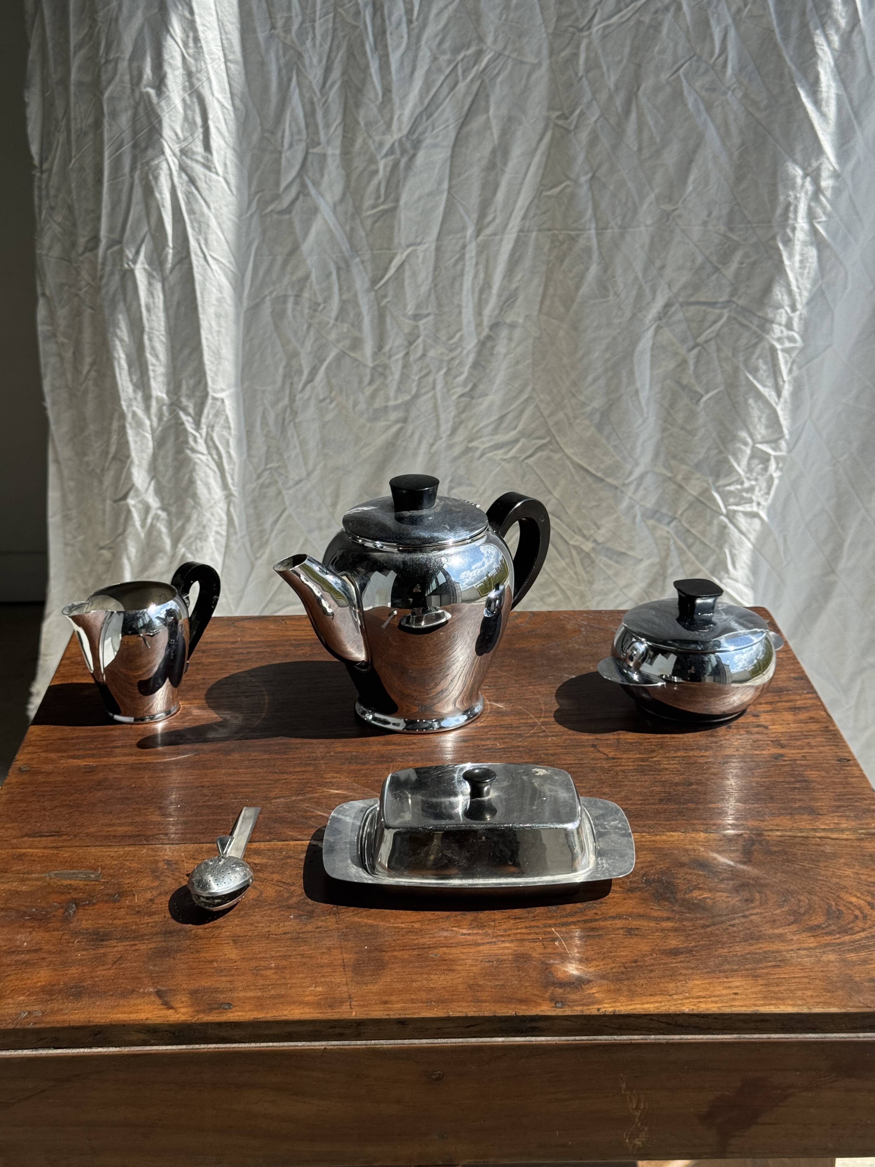 Tea set including teapot, milk jug, sugar bowl and butter dish