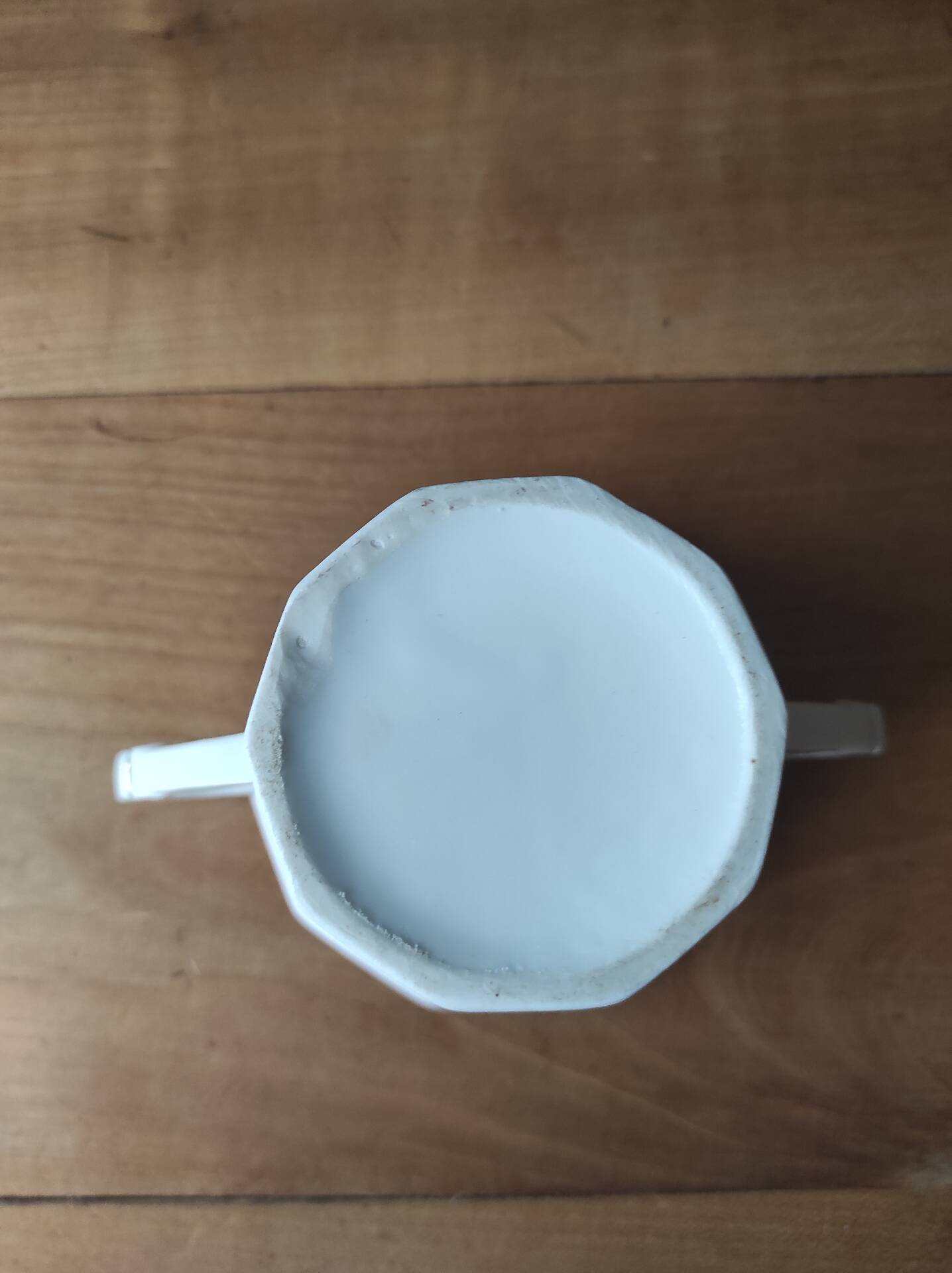 Antique porcelain sugar bowl with a decagonal base.