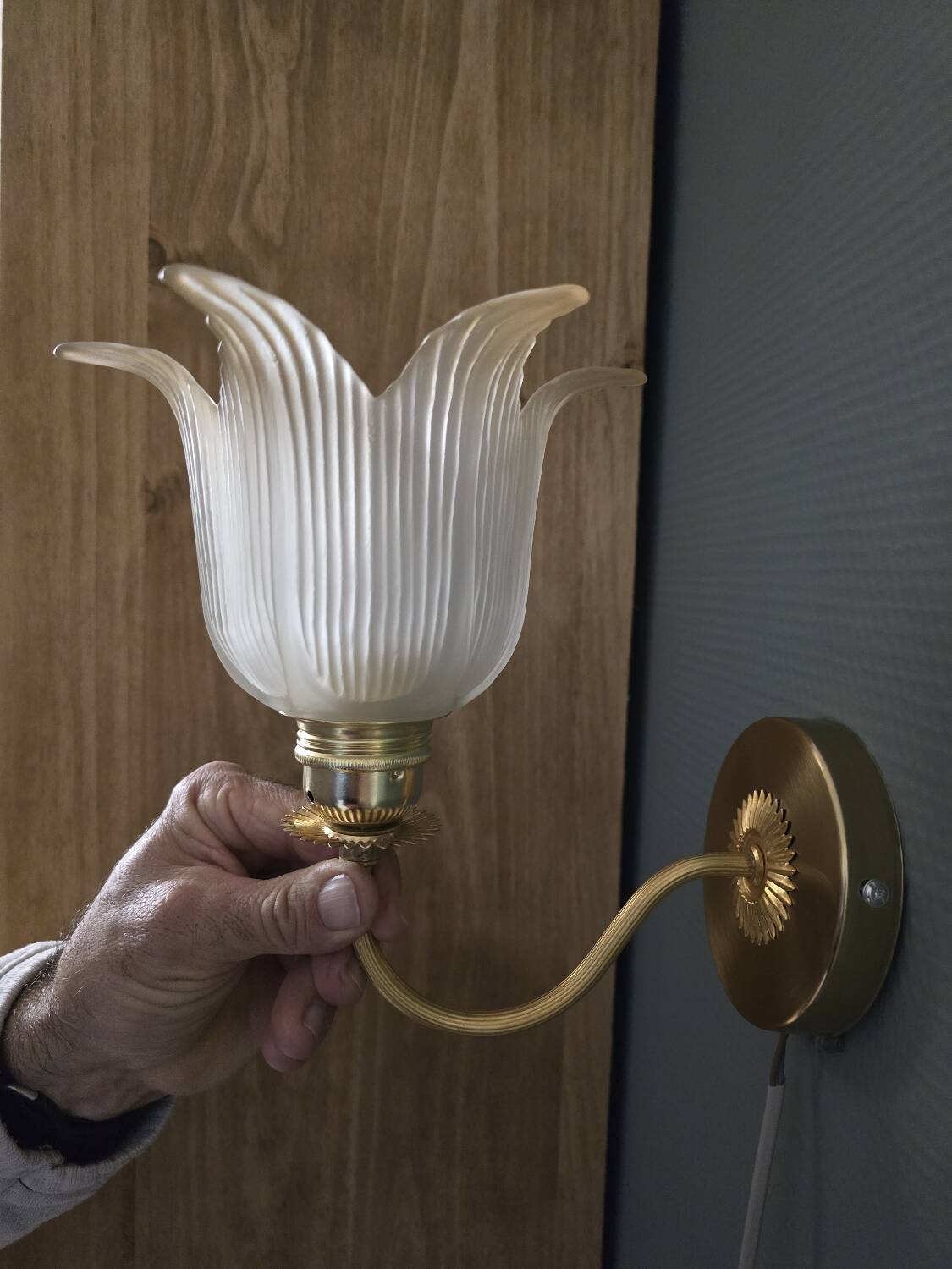 Frosted glass wall sconces and gilded brass in Art Deco style.