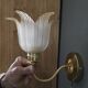 Frosted glass wall sconces and gilded brass in Art Deco style.