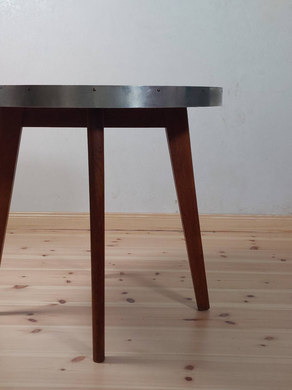 Vintage metal and teak side table from the 1950s.