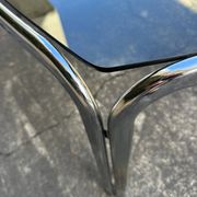 Vintage curved rectangular dining table in smoked glass and metal.