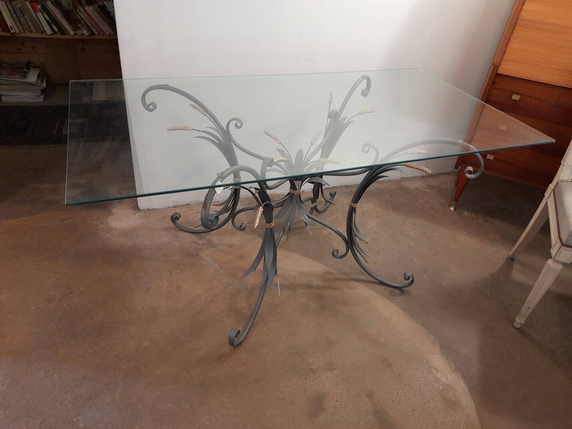 Glass top table with iron base in the style of wheat ears. Attributed to Robert Goossens.