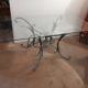 Glass top table with iron base in the style of wheat ears. Attributed to Robert Goossens.