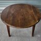 Antique round farmhouse table with drop-leaf doors in solid pegged wood