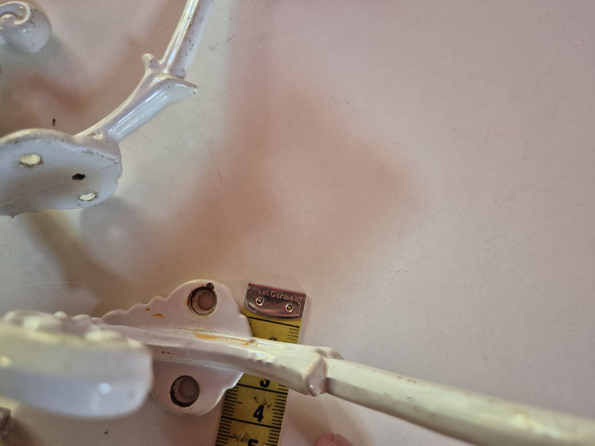 set of 2 vintage white cast iron hooks, small paint chips from the year