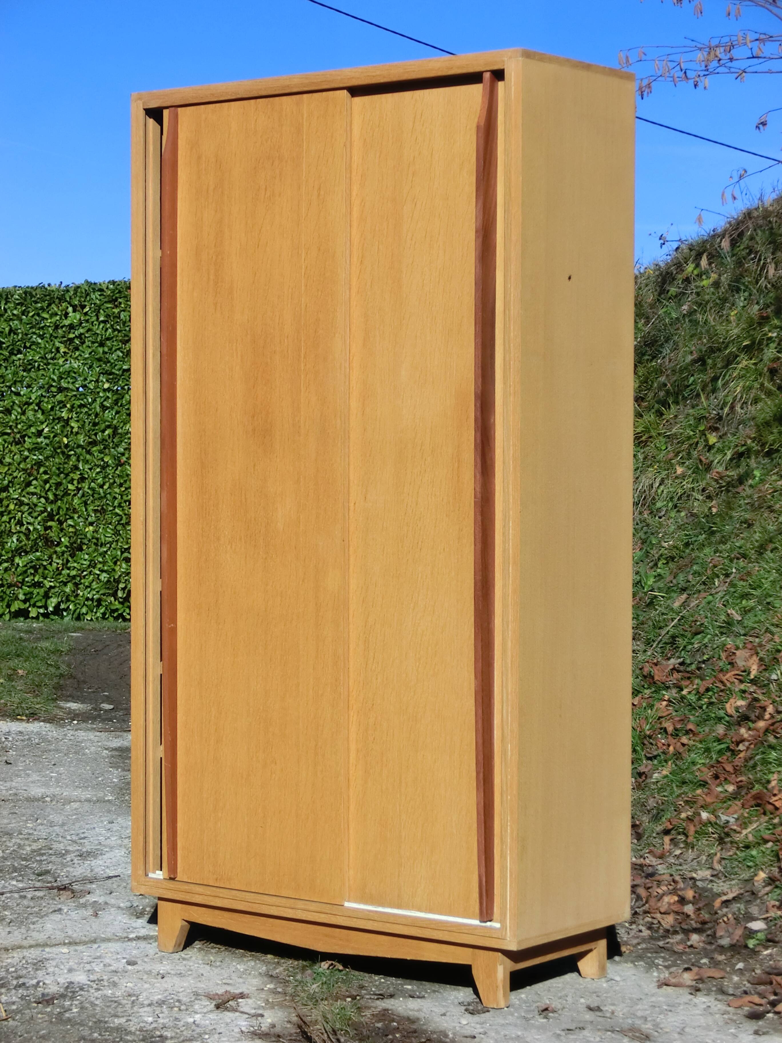 Small Scandinavian wardrobe with sliding doors - 1 side for hanging clothes.