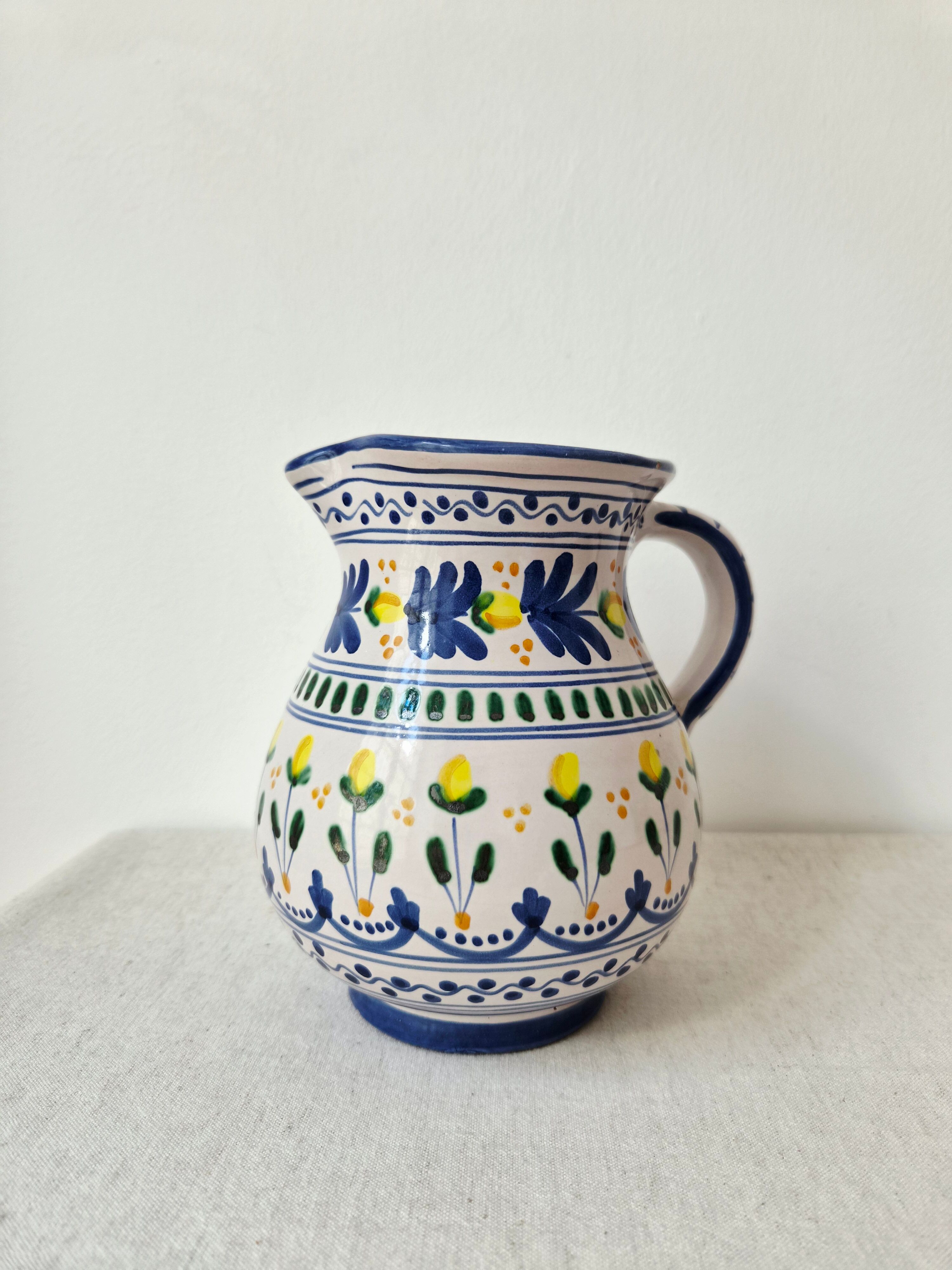 Vintage ceramic pitcher/vase hand-painted with floral decoration.