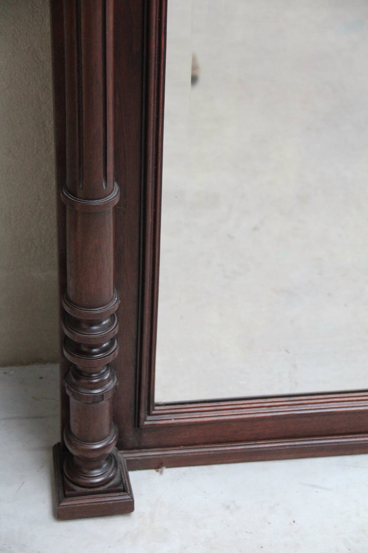 Imposing beveled mirror with wooden frame