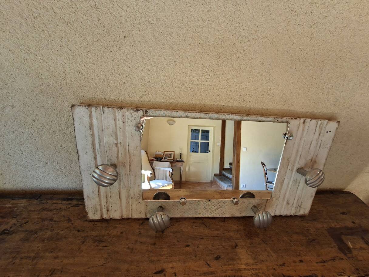 Wall-mounted coat rack with a patinated mirror
