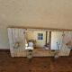 Wall-mounted coat rack with a patinated mirror