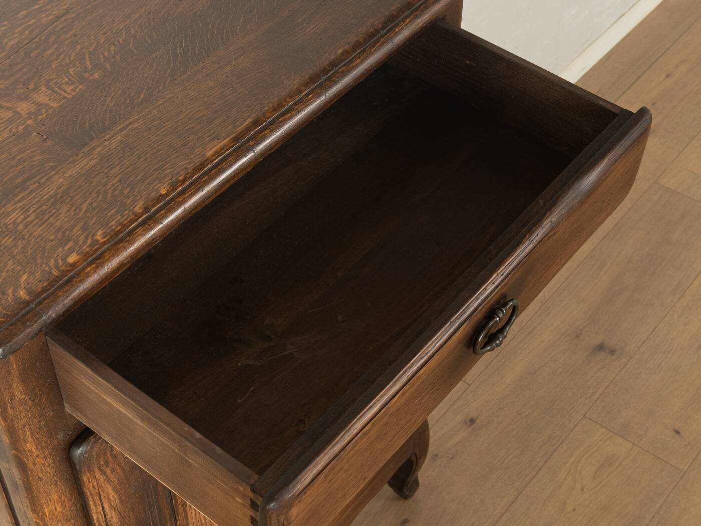 Antique chest of drawers with curved silhouette and patina