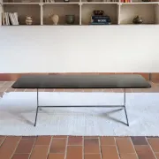 70s design coffee table with a black top and steel legs.