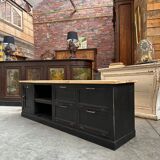 Old workshop furniture transformed into a TV unit.