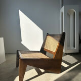 Reclined armchair in canned teak in natural wood