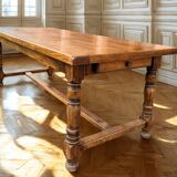 Large farmhouse table made of solid wood.